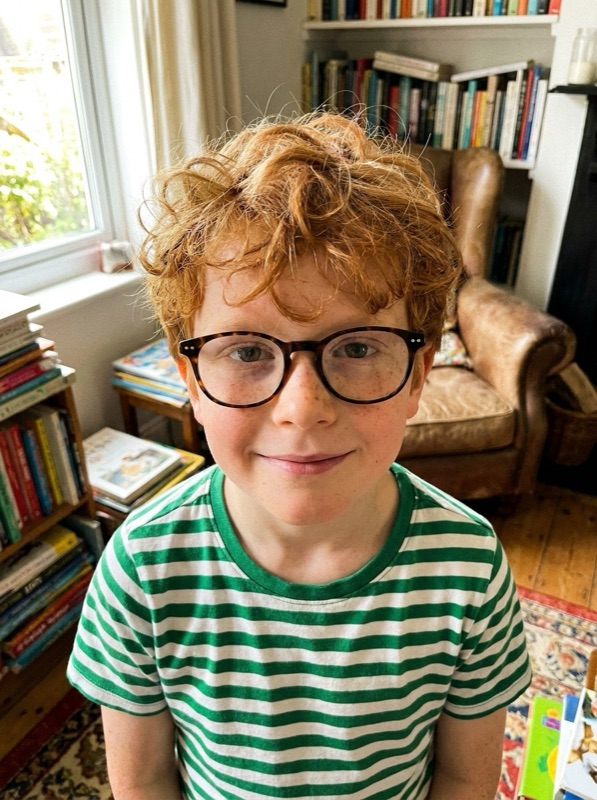 An AI-generated example photo of a boy with red curly hair and glasses